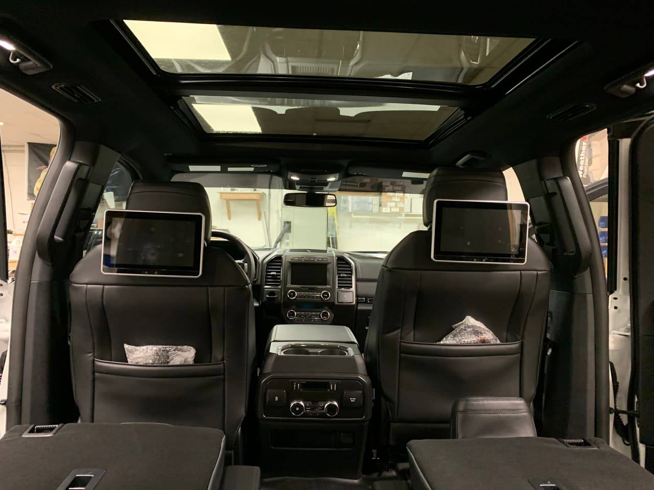 Two rear headrest DVD screens installed in an SUV