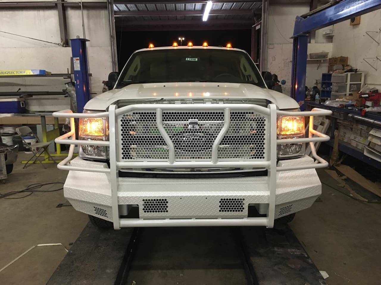 White Ford Super Duty with a brush guard installed at Performance Tinters II